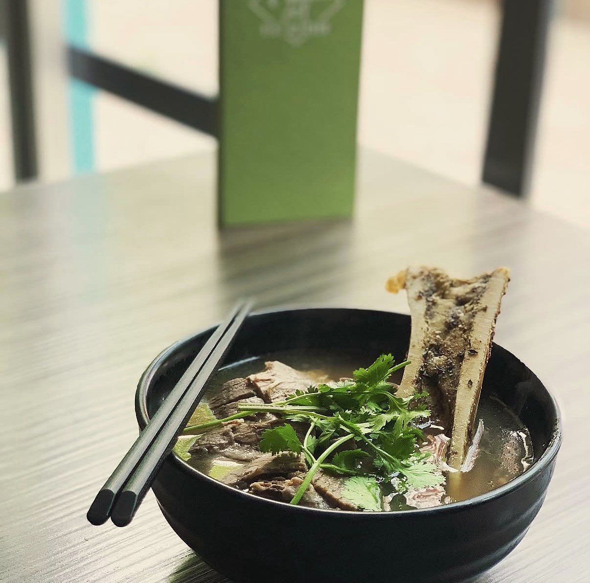 Phở Sườn with a roasted marrow bone and cilantro